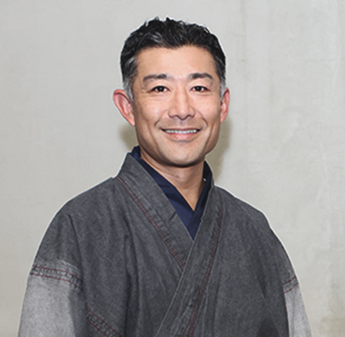 A picture of the CEO of Shikohin, Takeshi Nobuhara. He lived on an island in Japan which taught him to value and respect nature, emphasizing harmony between humans and the environment.